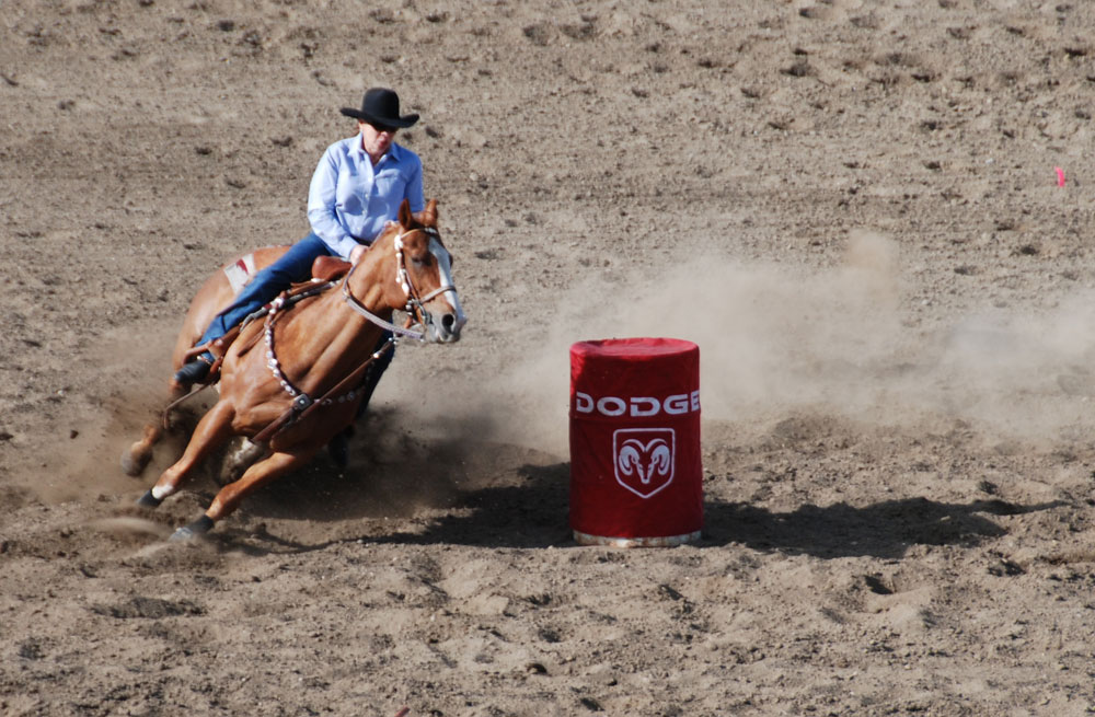 Barrel racer turning a barrel, long view, High River, AB, 2010