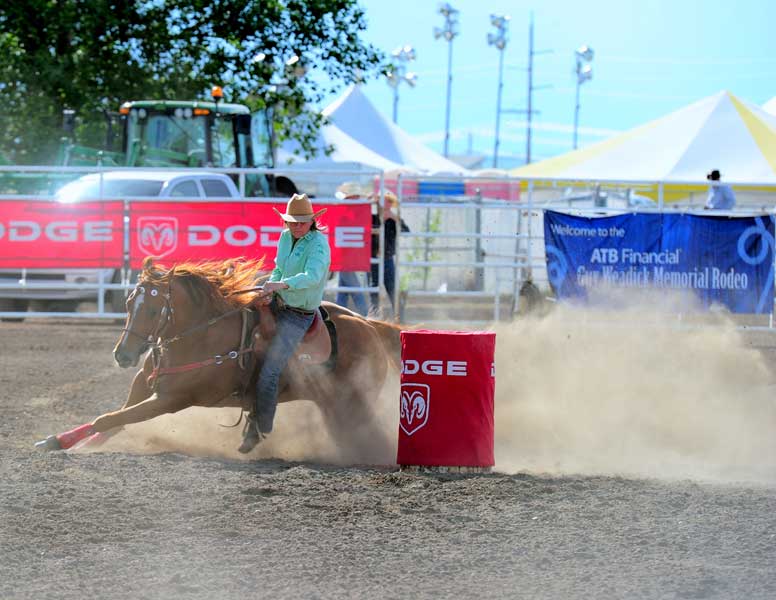 Barrel racer turning a barrel, High River, AB, 2010